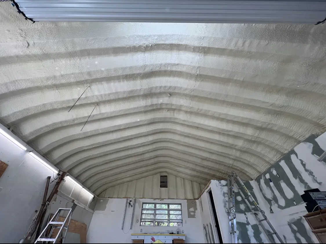 Spray polyurethane foam applied to the underside of a metal roof deck in Brighton